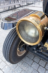 
The front fender of a retro car with a headlight on it