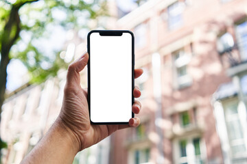 Man holding smartphone showing white blank screen at street