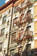  Exterior of a building with old fire escape in  New York City