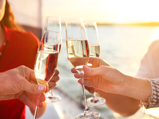 Happy friends with glasses of champagne on yacht. Vacation, travel, sea and friendship concept © Dasha Petrenko
