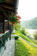 Porch of a wooden house in the forest on the river bank