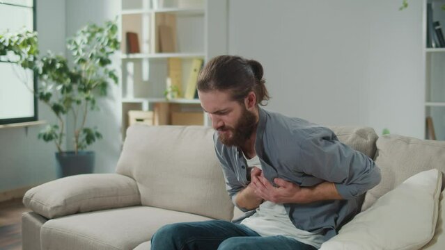 Man has Got the Symptoms of Heart Attack. Breathing Problems, Chest Pain. has Difficulty Breathing, Hand Touches Chest. Heart Attack, Thoracic Osteochondrosis, Panic Attack