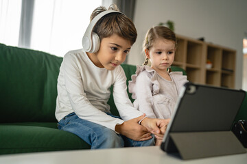 Brother sister siblings use digital tablet at home watch online video