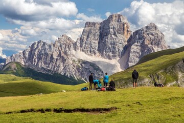 tourists on meadow mount Pelmo Alps Dolomites mountains