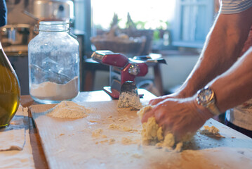 Male hands kneading dough	
