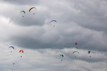Paragliders flying in a cloudy sky