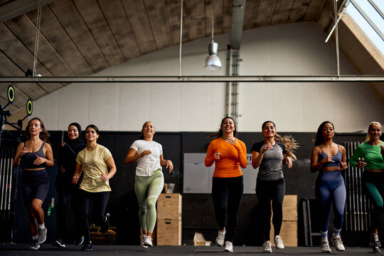 Laughing women running in a gym