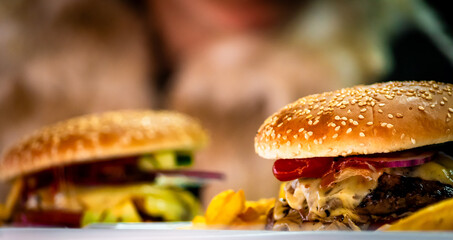 Freshly made bacon cheeseburgers with juicy tomato, lettuce and melted cheese. Food porn, smash burger.