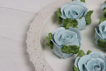 Homemade zephyr spread out on a tray. Flowers from zephyr.  Close-up.
