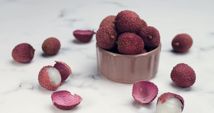 Lychee tropical fruit in glass bowl. Litchi contains essential nutrients, vitamins, antioxidants and minerals. Litchi protects against oxidative stress, heart diseases, diabetes, cancers. Healthy food