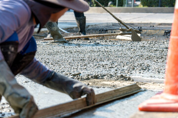 Cement mortar work. Construction trowel level tools. Asphalt road.
