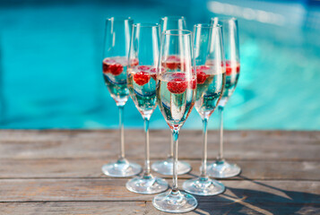 Champagne glasses with raspberry