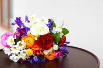 Unusual bright wedding bouquet with ranunculus