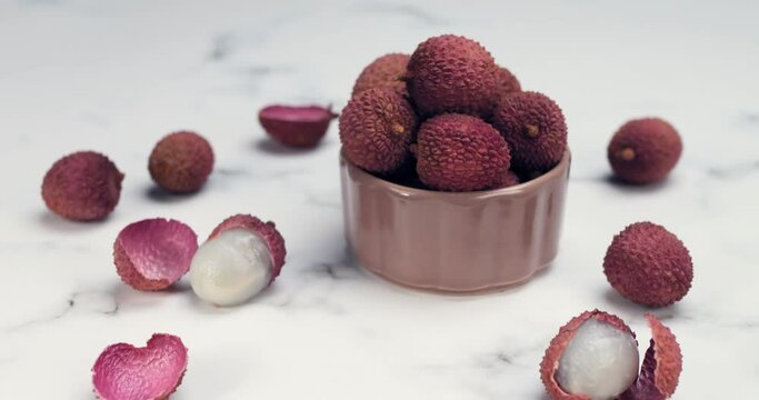 Lychee tropical fruit in glass bowl. Litchi contains essential nutrients, vitamins, antioxidants and minerals. Litchi protects against oxidative stress, heart diseases, diabetes, cancers. Healthy food