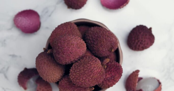 Lychee tropical fruit in bowl. Litchi contains essential nutrients, vitamins, antioxidants and minerals. Litchi protects against oxidative stress, heart diseases, diabetes, cancers. Healthy food conce