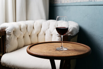 Still life shot of glass with red wine on vintage table. Elevated Wine Experience