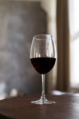 Low angel view of glass with red wine in the bar