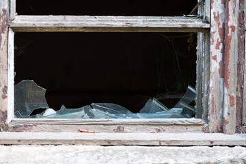 Smashed glass Window with old wooden frame. old window. finely broken glass. old house, retro....