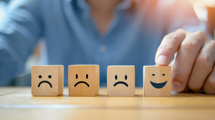 Naklejka premium Conceptual image of a person choosing a happy face among sad ones, symbolizing positivity or satisfaction.