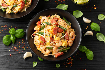 Char kway teow with rice noodles, prawn, sausages, egg and vegetables