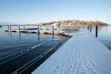 Swedish harsh beautiful winter concept: sunny view after snowfall on outdoor swimming area sometimes used by winter swimmers