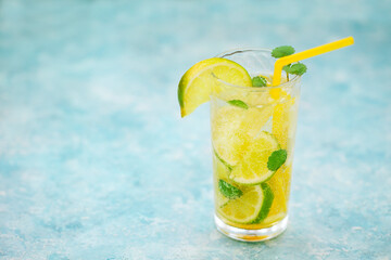 Glasses of homemade lemonade on a rustic wooden background