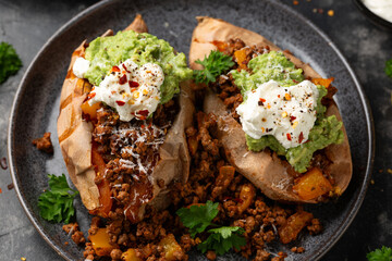 Taco Sweet Potatoes stuffed with ground beef, cheese, guacamole, sour cream