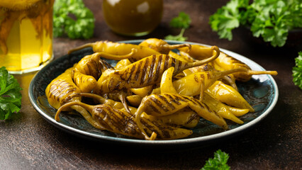 Grilled Pickled Green jalapeno chillies on plate. Healthy hot food