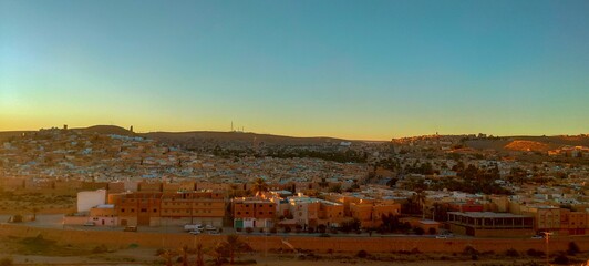 Panoramic view from the highest of the hill on the town of Ghardaia, With its narrow alley, its clay and stone houses at sunset, typical architecture of the sub-Saharan desert, M'zab Oasis, Algeria