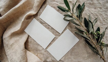 wedding stationery still life concept set of blank cotton paper business place cards or invitations mockups olive tree branch on beige linen table cloth background minimal flat lay top view - obrazy, fototapety, plakaty