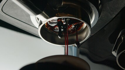 Coffee espresso machine pulling double shot espresso from bottomless naked portafilter. 