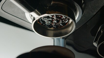 Coffee espresso machine pulling double shot espresso from bottomless naked portafilter. 