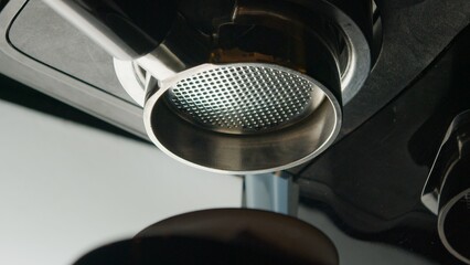 Coffee espresso machine pulling double shot espresso from bottomless naked portafilter. 