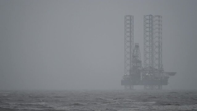 Gas rig situated off Ainsdale beach on cloudy and stormy day