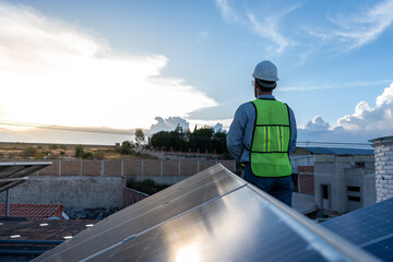 engineer looking at the horizon after installing solar panels, concept of hope in renewable energy power, unrecognizable technician working at sunset - obrazy, fototapety, plakaty