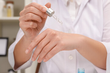 Dermatologist testing cosmetic product in laboratory, closeup