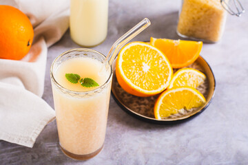 Diet orange smoothie with rice milk in a glass on the table