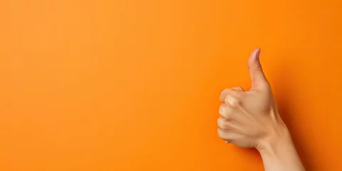  An arm sticks out of an orange wall and shows a thumbs up © Creative Canvas