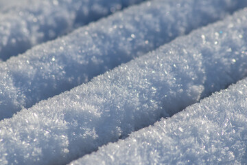 Ice crystals macro in close-up view shows beautiful ice structures of frozen water with spikey...