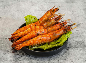 Grilled shrimp with salt and chili or tom nuong muoi ot with lettuce leaf served in dish isolated on grey background top view of singapore seafood