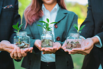 Concept of sustainable money growth investment with glass jar filled with money savings coins with...