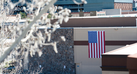 American flag hanging on side of building.