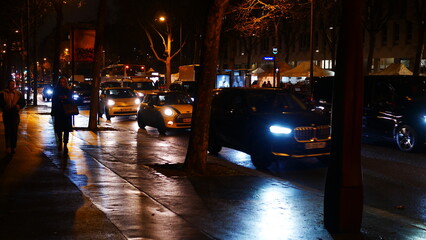 Rue ou avenue avec circulation de voitures ou de taxis, la nuit, coin sombre, phrases éclairées,...
