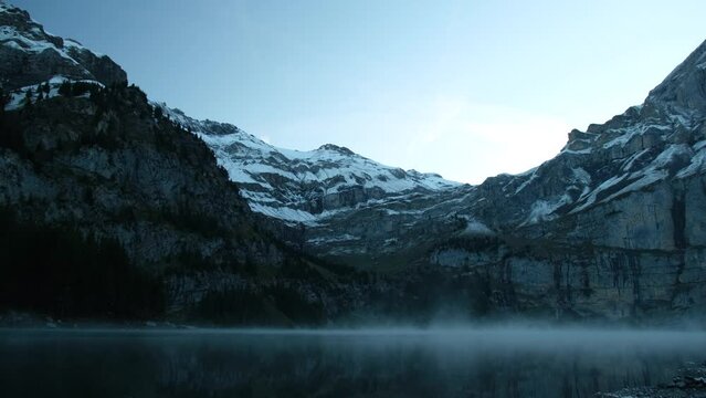Mysterious morning mist over mountain lake. Stady shot