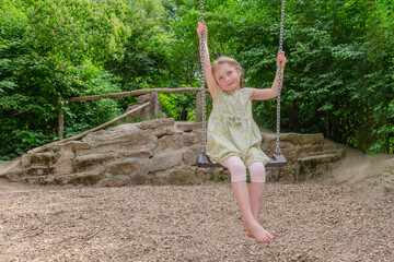 A five year old girl on a swing