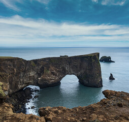 Fototapeta na wymiar Picturesque autumn evening view to Dyrholaey coast cliffs and rocky arch, Vik, South Iceland.