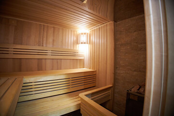 Interior of Finnish sauna, classic wooden sauna with hot steam. Russian bathroom.