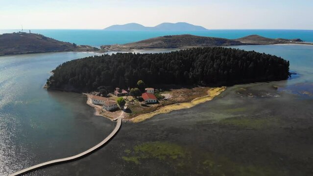 Drone aerial view on isolated Monastery of Saint Mary on Zvernec island Narta Lagoon, Vlore, Albania