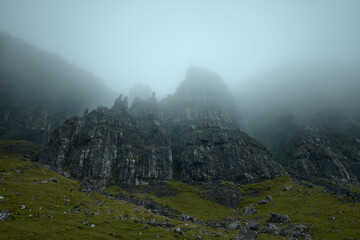 Atmospheric view of high sharp cliffs covered in fog. The Old Man of Storr covered in fog. The Isle of Skye, Scotland, UK