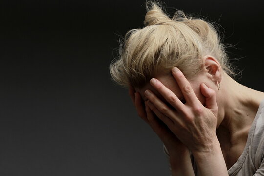 Woman Praying With Hand Over Her Face On Black Background With People Stock Image Stock Photo